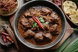 A bowl of beef stew with spices and herbs photo