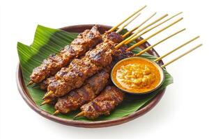 A plate with skewers of meat and sauce photo