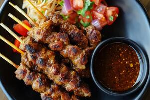 A plate with meat skewers and sauce photo