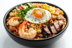 A bowl of rice with shrimp, pork and an egg photo