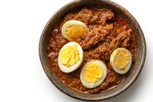 A bowl of food with eggs and meat photo