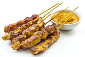 Chicken satay on sticks with dipping sauce photo