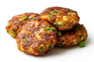 Three meat patties with green onions on a white background photo