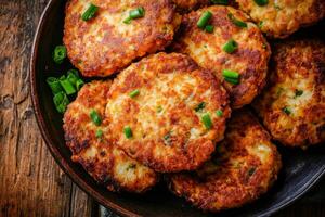A plate of fried potato cakes with green onions photo