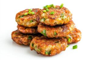 A pile of crab cakes with green onions photo