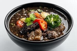 A bowl of soup with meat and vegetables photo