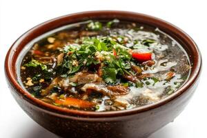 A bowl of soup with meat and vegetables photo