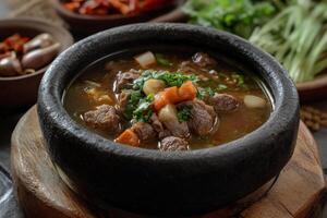 A bowl of soup with meat and vegetables photo