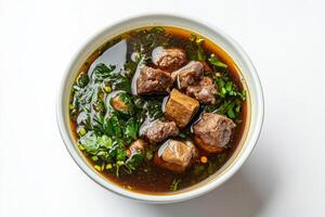 A bowl of soup with meat and vegetables photo