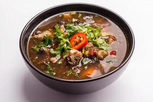 A bowl of soup with meat and vegetables photo