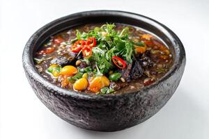 A bowl of soup with vegetables and meat in it photo