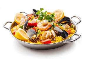 Paella with seafood and rice in a pan on a white background photo