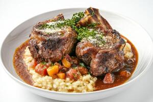 A plate of meat and vegetables with a sauce photo