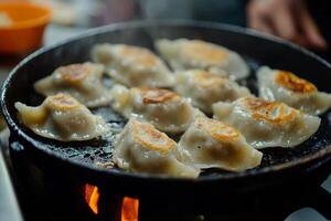 Dumplings are cooking in a pan on a stove photo