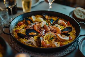 A paella is served in a pan with seafood and rice photo