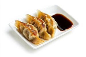 Three dumplings on a white plate with sauce photo