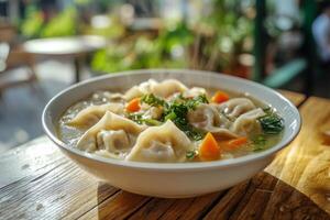 A bowl of soup with dumplings and vegetables photo