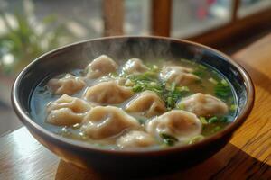 A bowl of soup with dumplings in it photo