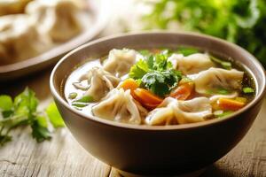 A bowl of soup with dumplings and vegetables photo