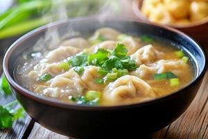 A bowl of soup with dumplings and vegetables photo