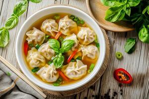 Chinese dumplings in a bowl with vegetables and herbs photo