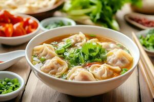 A bowl of soup with dumplings and vegetables photo