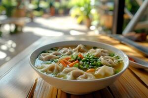 A bowl of soup with dumplings and vegetables photo