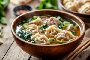 Chinese dumplings in soup with chopsticks photo
