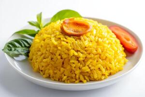 Yellow rice with tomato and basil on white plate photo