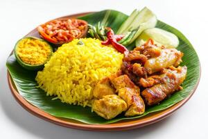 A plate with yellow rice, chicken and vegetables photo
