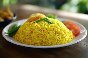 A plate of yellow rice with vegetables and a tomato photo
