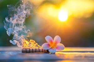 A flower and smoke coming out of a wooden stick photo