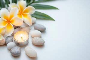 Spa concept with white flowers and stones on white background photo