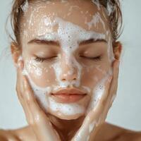 A woman with a face covered in soap photo