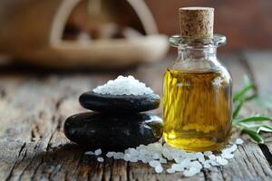 A bottle of oil and salt on a wooden table photo