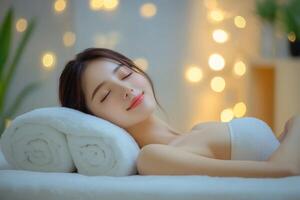 A woman laying on a towel in a spa room photo