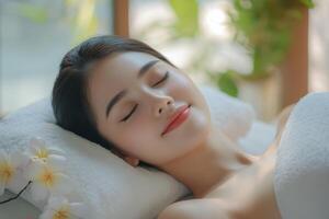 A woman laying on a massage table with flowers photo