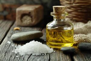 A bottle of oil and salt on a wooden table photo