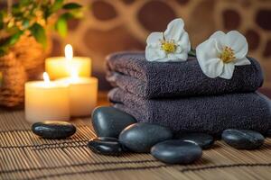 Spa towels and candles on bamboo mat photo