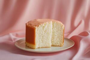 A slice of cake on a plate on a pink background photo