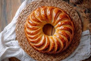A large round cake on a wooden table photo