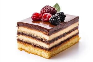 A piece of cake with chocolate frosting and berries photo