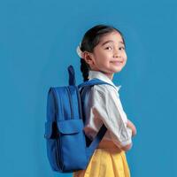 A little girl with a blue backpack photo