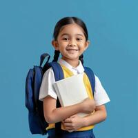 A little girl in school uniform holding a book photo