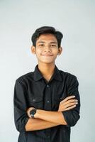 Portrait of young asian man with arms crossed on white background photo