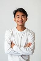 Portrait of asian young man with arms crossed standing on white background photo