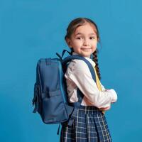A little girl in a school uniform with a backpack photo