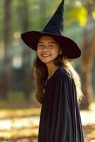 A little girl in a black witch hat photo