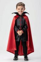 A young boy dressed in a vampire costume photo