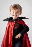 A young boy dressed in a vampire costume photo